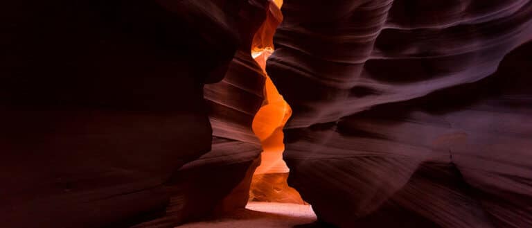 Plato's cave analogy: Antelope Canyon's sandstone walls glow with light. The narrow slot canyon represents Plato's Cave, a metaphor for perception.