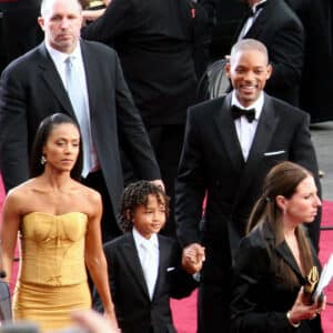 Will Smith, Jada, and Jaden at an event. The Dark Side of Honour may involve scrutiny of celebrity families and their public personas.