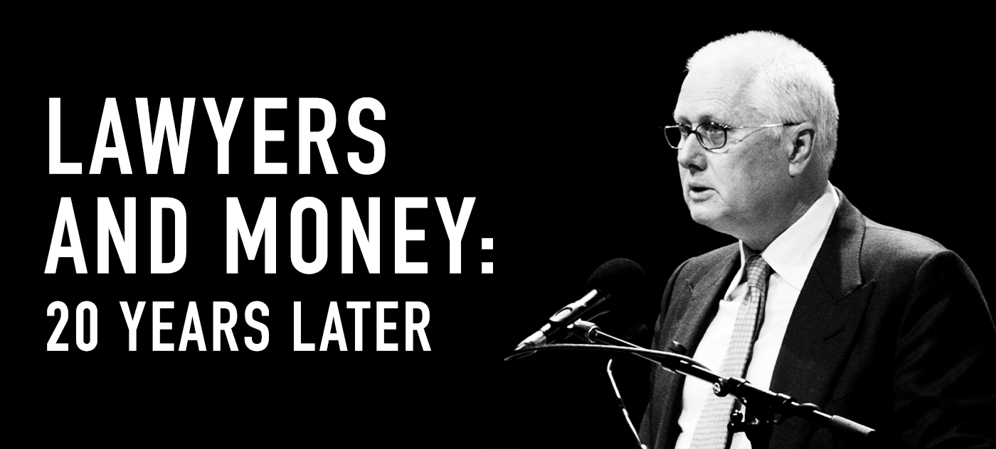 Lawyers and Money: 20 Years Later. Black and white image featuring a speaker at a podium with microphones, discussing lawyers finances.