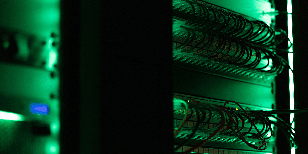 Server room illuminated in green light, representing AI infrastructure. Focus on the ethics of AI's untaxed future and digital economy.