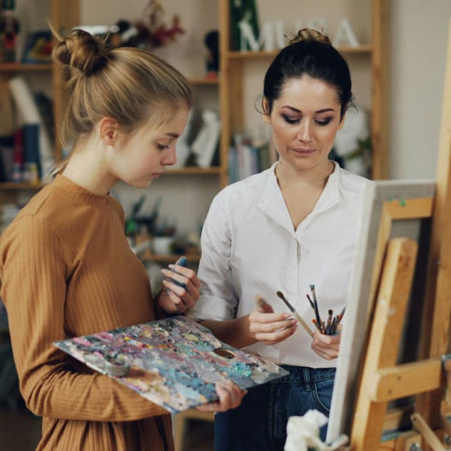 A student confides in her teacher during an art lesson. The student holds a palette, while the teacher holds brushes. Should I tell the parents?