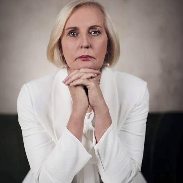 Ethics of Surrender: Woman in white suit with hands clasped, pondering the complexities of surrender and ethical considerations.