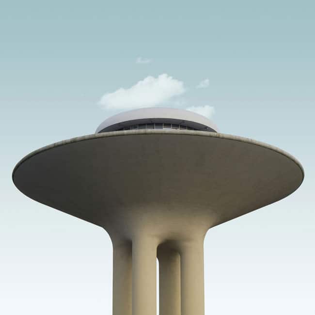 Unique water tower architecture resembling a UFO, sky background. Relates to conspiracy theories and unconventional perspectives.