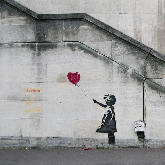 Banksy-style graffiti art: Girl reaches for red heart balloon, symbolizing lost innocence. Anonymity, behind the veil, unmask the anonymous.