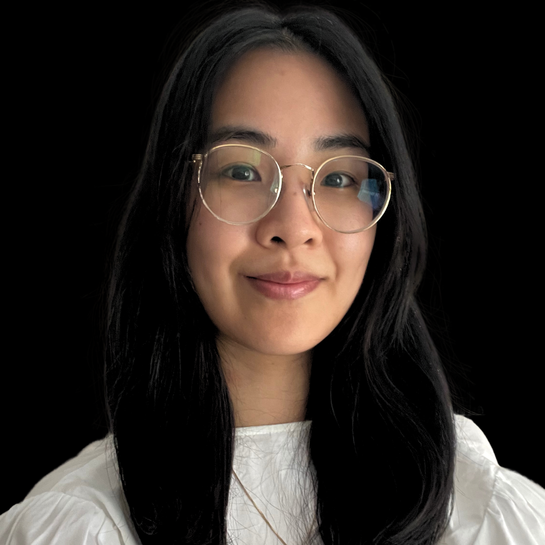 Cecelia Thai portrait: A young woman with long black hair, wearing glasses and a white shirt, smiles against a black background.