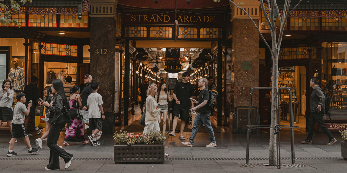 Shoppers stroll outside Sydney's Strand Arcade, a covered Victorian-style shopping centre. Australian businesses and Inequality are evident in society.