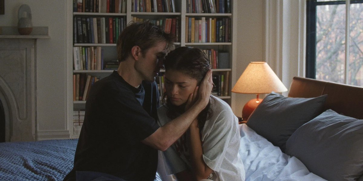 Drama scene with a man comforting a woman on a bed. Exploring what it means to lie to those we love, the image captures a moment of emotional intensity.