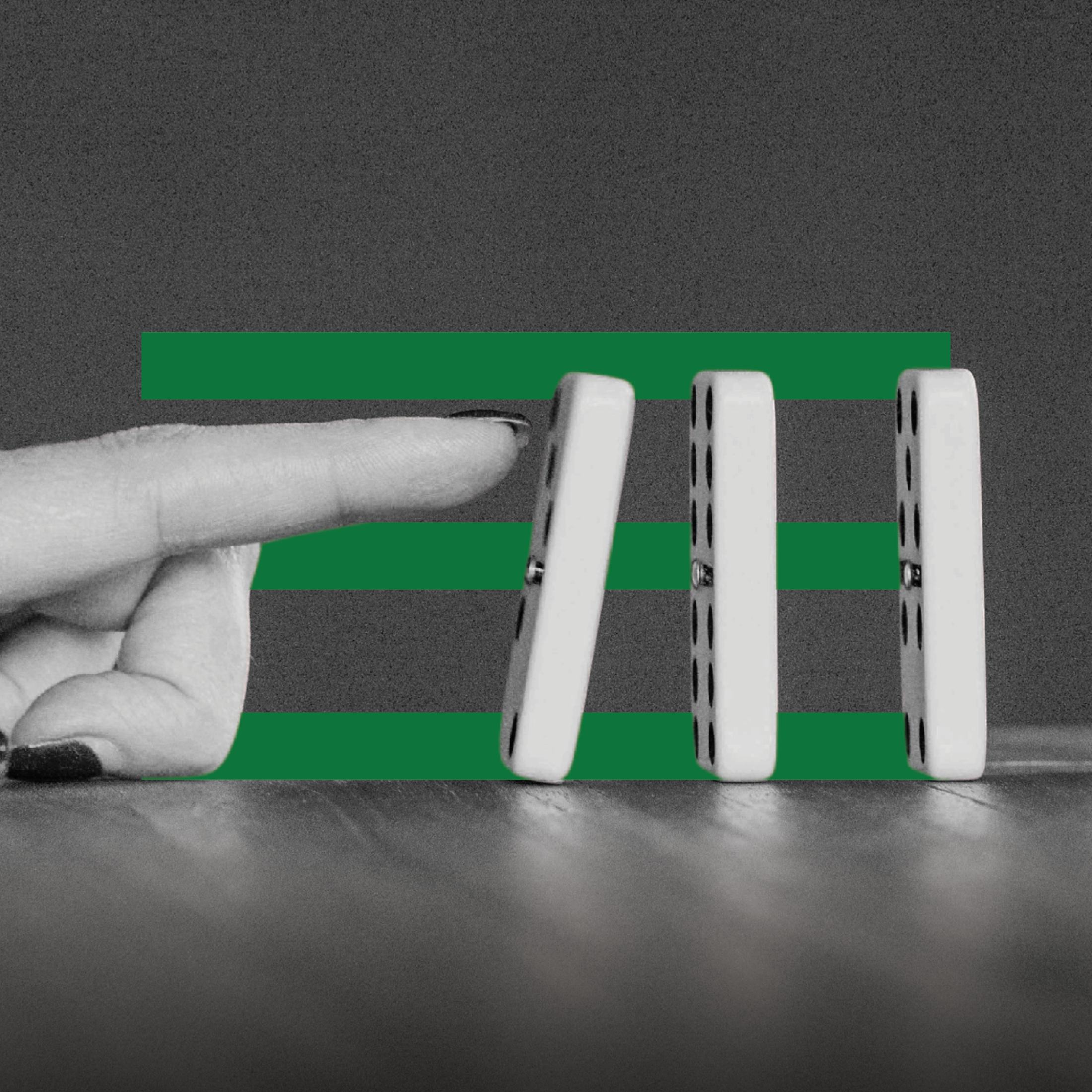 Finger pushing dominoes with green stripes symbolizing the ethics of happiness and chain reactions.