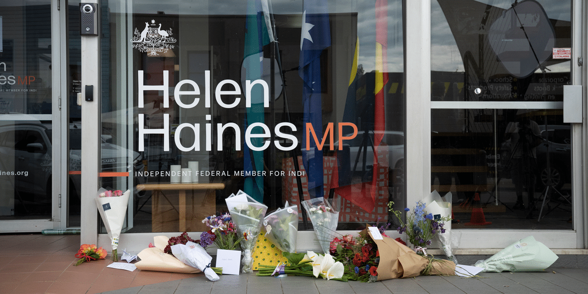 Bouquets of flowers rest outside the glass office of Helen Haines MP, Independent Federal Member for Indi