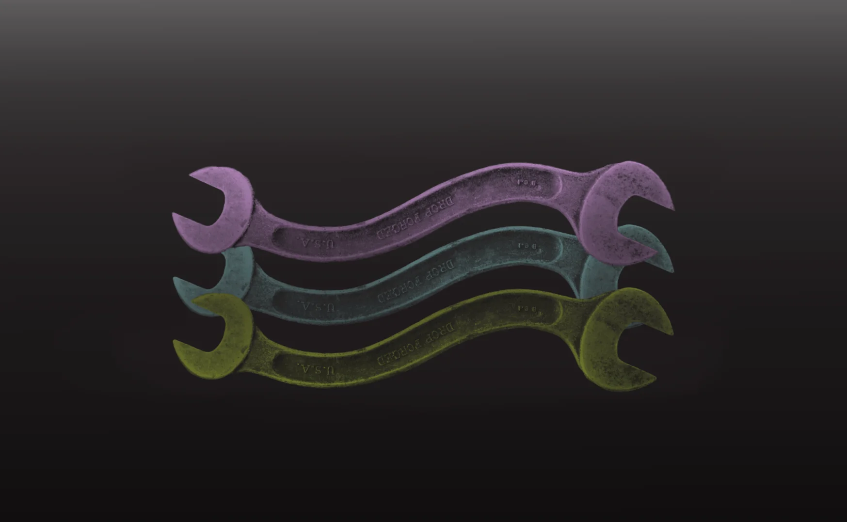Colorful wrenches stacked on a black background. Tools in purple, blue, and yellow. Drop forged USA wrenches. Industrial tool background.