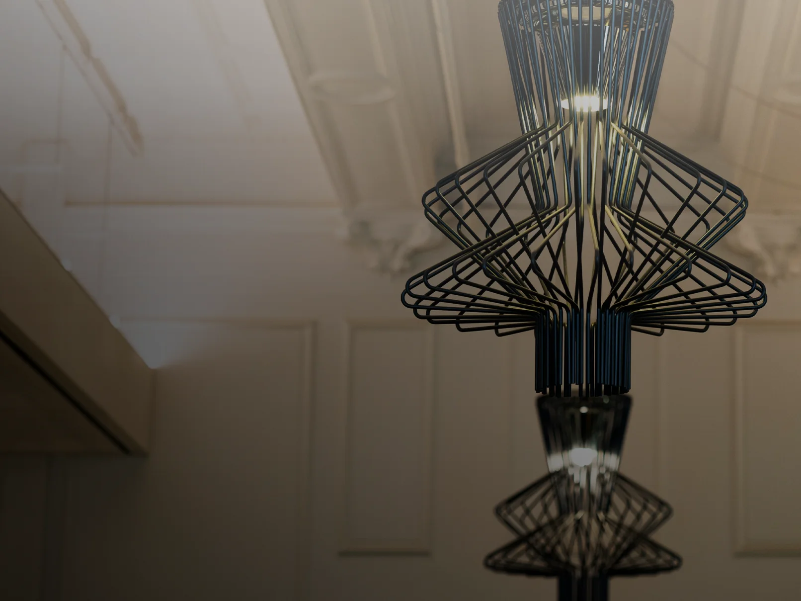 Modern chandelier. Black metal wireframe pendant light fixture with geometric design. Interior lighting with a warm glow, against a neutral wall and ceiling.